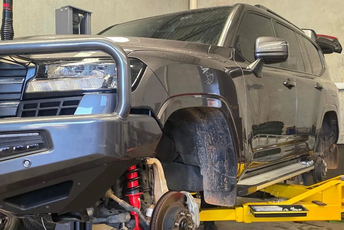 4WD up on a hoist with a wheel off during a repair at Shanno&rsquo;s