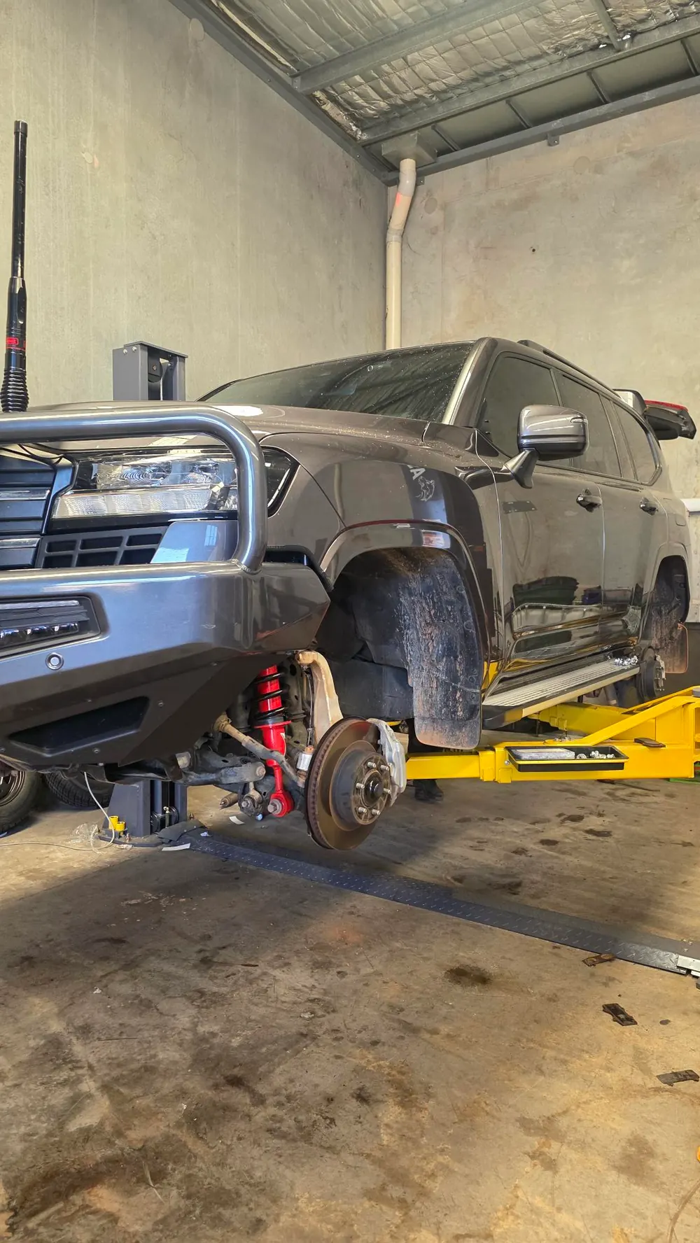 4WD up on a hoist with a wheel off during a repair at Shanno&rsquo;s